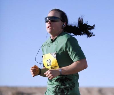 Hayley running with a blue sky backbround.