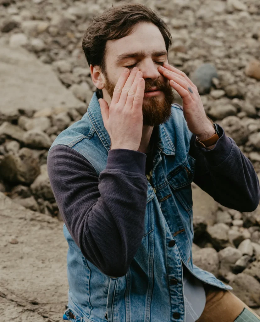 Man toughing his face